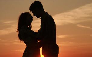 Couple in Love silhouette at Sunset sky