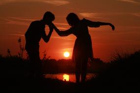 silhouettes of a couple in love at dusk