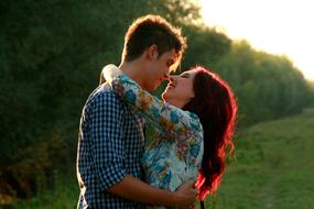 young Boy and Girl hugging at forest