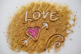 heart and love on golden sand