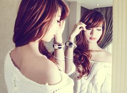 Girl, with the make-up, posing in front of the mirror