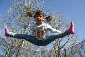 Happy child girl jumps Outdoor