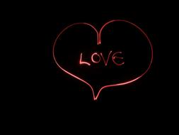 Beautiful, red heart with the "LOVE" sign, at black background, clipart