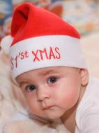 little child wearing santa claus hat