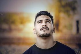 portrait of a young man looking at the sky