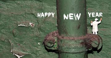 happy new year, Miniature Figure beneath writing on grunge wall