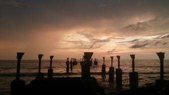 silhouettes on the beach at dusk