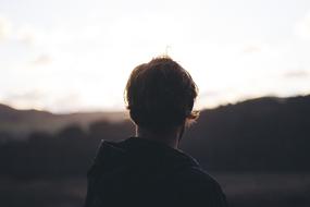 Man at blur landscape, back view