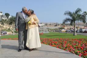 Happy senior asian wedding Couple kissing in park