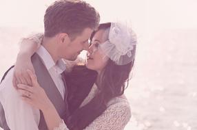 Couple, posing together, on the beach, in light