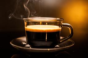 a cup of hot aromatic coffee on the table