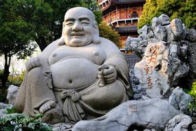 smiling buddha stone sculpture
