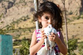 portrait of kid girl with dove