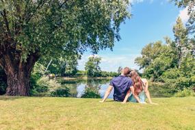 couple in love sitting by the lake