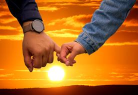 male and female hands together at Sunset sky, collage