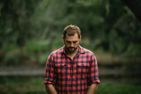 photo of man in red and black shirt