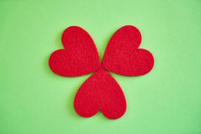 three red Hearts Figure at green background