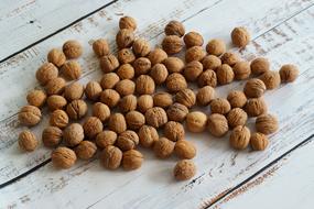 brown walnuts lie on white boards