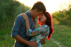 kiss of lovers in nature at dusk
