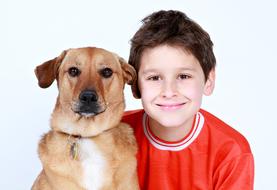 boy in a red t-shirt with a pet dog