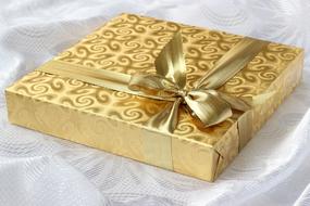 Beautiful, patterned gold gift box with the ribbon