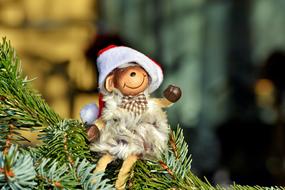 funny sheep figurine sits on Christmas Tree