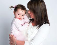 mom with daughter in her arms on a white background