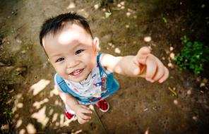 Portrait of the boy kid, pointing up, with the finger