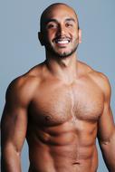 Portrait of a smiling man with beard, and bare chest