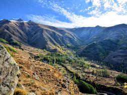 Beautiful and colorful mountains at blue sky with white clouds in autumn