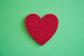 rag red heart on green background