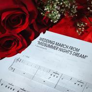 red roses and notes of the wedding march