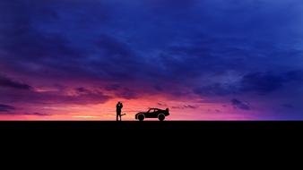 silhouette of a couple near the car at dusk