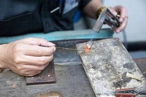 Close-up of the hands and tools of a working man in Thailand