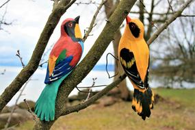 two colorful Birds, garden decoration on tree