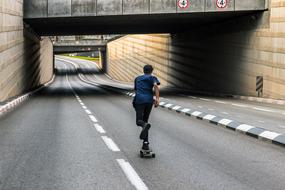 roller Skating on road beneath bridge