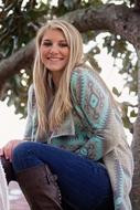 smiling blonde on a tree background