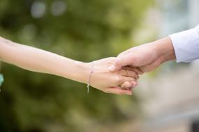 slim Hand of girl in male hand
