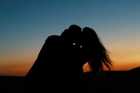 silhouette of a couple in love at sunset