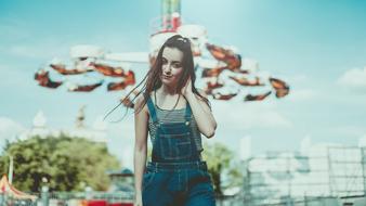 young girl in front of Attractions in amusement Park, russia, Moscow