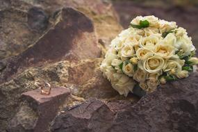 Wedding Ring and flowers on Rocks