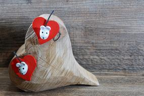 Valentineâs Day greeting, hearts and mice at wooden background