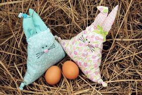 two Easter Bunny shaped pillows and eggs