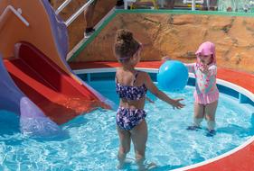 children playing with a ball in the pool