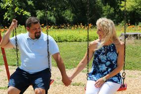 couple in love on a swing on a sunny day