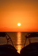 landscape of two boats in front of sea at Sunset