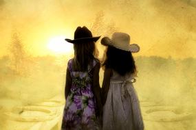 Silhouettes of the girls in colorful dresses, in western hats, on the beautiful and colorful landscape