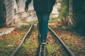 lonely man walks on rails