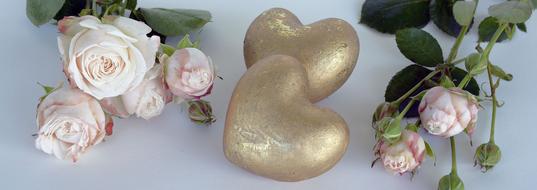 golden hearts and roses as a symbol of romance