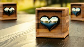 Beautiful, wooden boxes with shiny hearts, on the wooden table in light